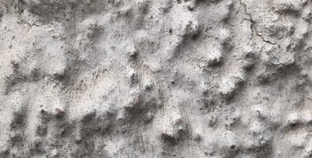 a close up of a rock wall with small holes in it