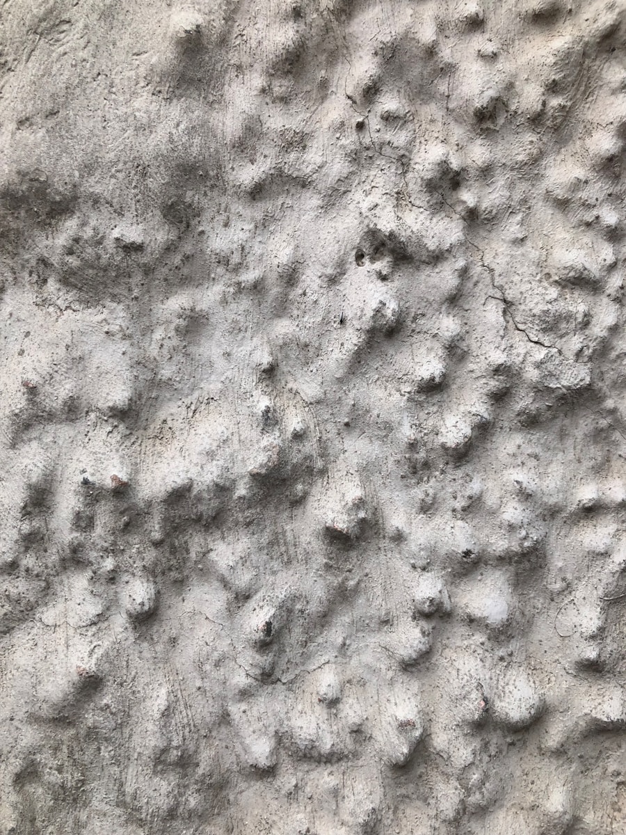a close up of a rock wall with small holes in it