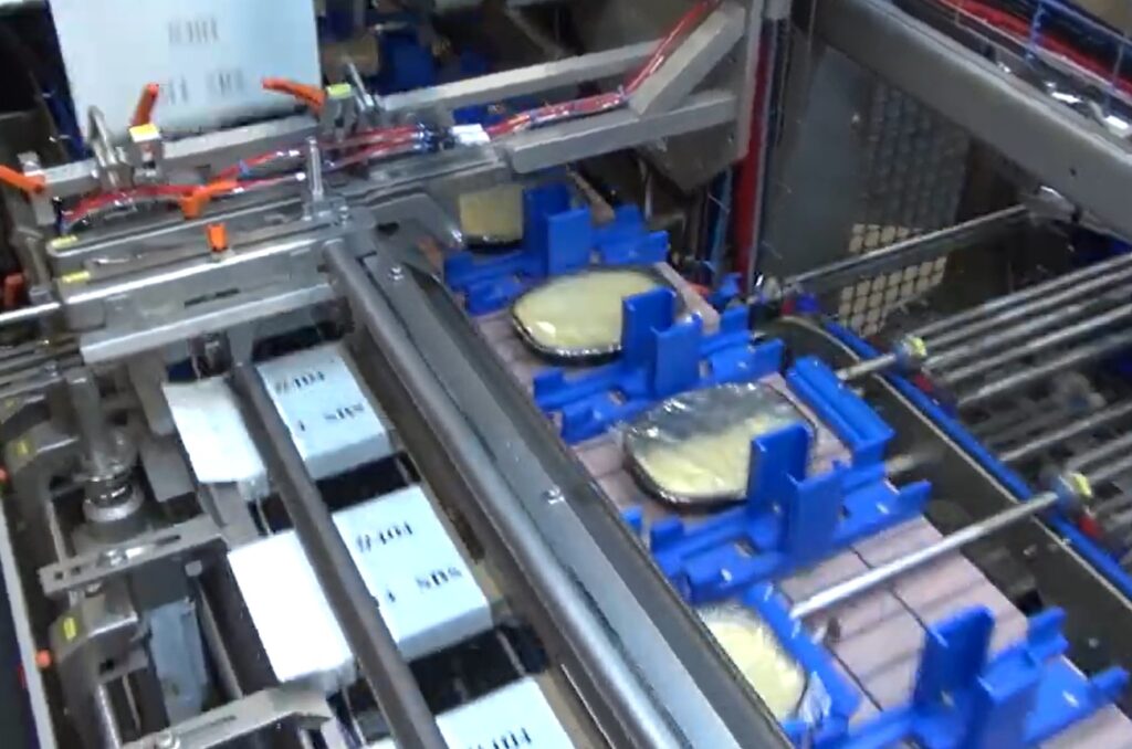 Carefully shooting frozen pizzas into boxes